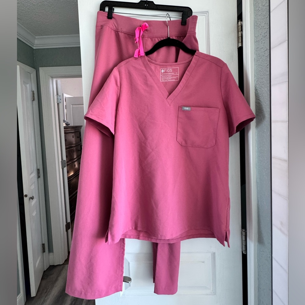 FIGS pink scrub pants and top with neon pink tie.
